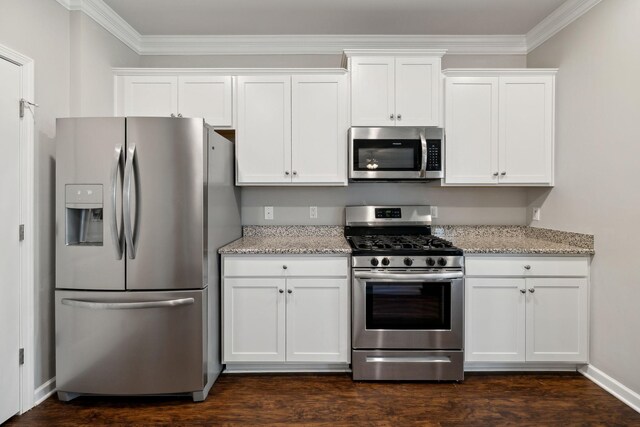 778 Prominence Rd, Columbia, TN 38401 - kitchen with stainless steel appliances, ornamental molding, white cabinetry, light stone counters, and dark wood-style flooring