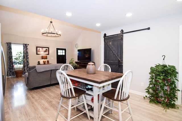 421 Marlin Ln, Westmoreland, TN 37186 - dining space featuring a barn door, light wood-style floors, lofted ceiling, baseboards, and a chandelier