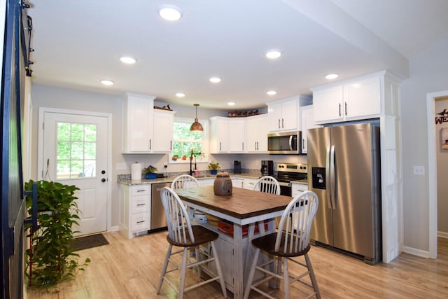 421 Marlin Ln, Westmoreland, TN 37186 - kitchen with appliances with stainless steel finishes, light wood-style flooring, white cabinetry, light stone counters, and recessed lighting