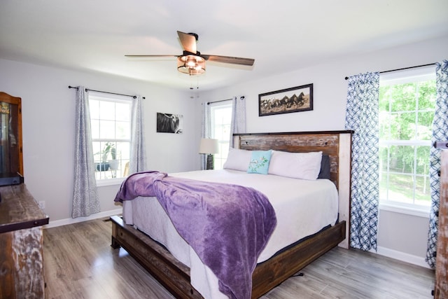 421 Marlin Ln, Westmoreland, TN 37186 - bedroom with multiple windows and wood finished floors