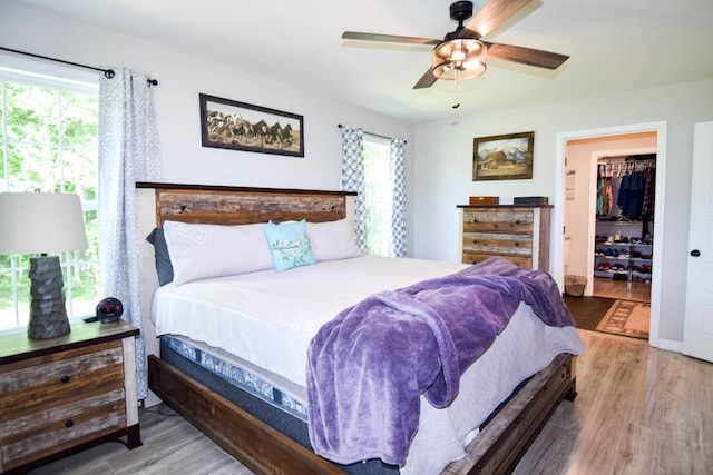 421 Marlin Ln, Westmoreland, TN 37186 - bedroom with wood finished floors, a spacious closet, and a ceiling fan