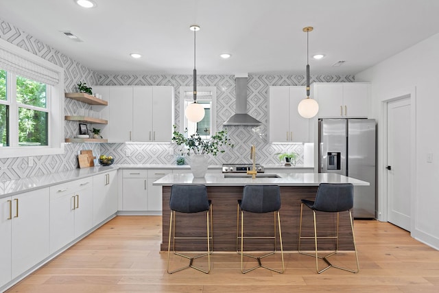 1003 Alice St Unit B, Nashville, TN 37218 - kitchen featuring wall chimney exhaust hood, stainless steel refrigerator with ice dispenser, open shelves, a sink, and a kitchen island with sink