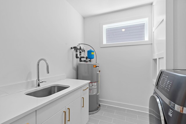 1003 Alice St Unit B, Nashville, TN 37218 - laundry area with cabinet space, electric water heater, washer / dryer, light tile patterned floors, and baseboards