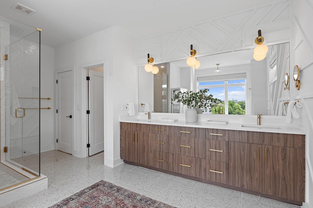 1003 Alice St Unit B, Nashville, TN 37218 - full bathroom featuring speckle patterned floor, a shower stall, double vanity, and baseboards