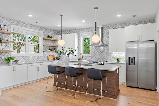 1003 Alice St Unit B, Nashville, TN 37218 - kitchen with stainless steel fridge, open shelves, wall chimney range hood, an island with sink, and light countertops