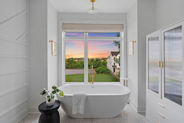 1003 Alice St Unit B, Nashville, TN 37218 - bathroom featuring speckle patterned floor, a soaking tub, and baseboards