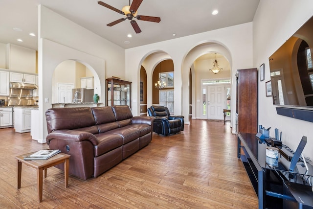3820 Leona Pass, Hermitage, TN 37076 - living room featuring arched walkways, a ceiling fan, light wood-style flooring, a towering ceiling, and recessed lighting