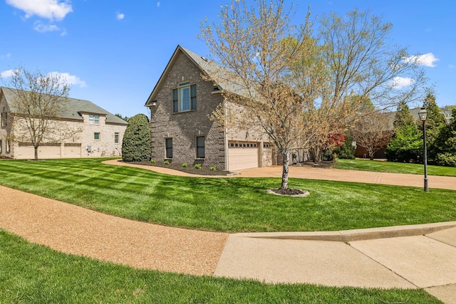 3820 Leona Pass, Hermitage, TN 37076 - view of side of home with a garage, a lawn, driveway, and stone siding
