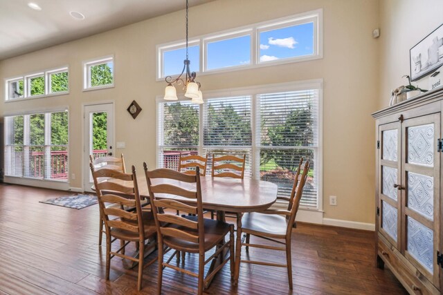 3820 Leona Pass, Hermitage, TN 37076 - dining room with dark wood finished floors, a towering ceiling, a chandelier, and baseboards