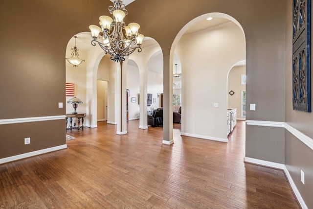 3820 Leona Pass, Hermitage, TN 37076 - entrance foyer featuring arched walkways, wood finished floors, a chandelier, baseboards, and a high ceiling