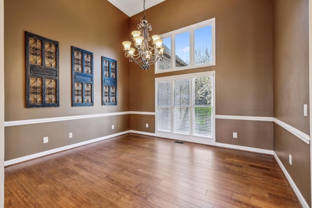 3820 Leona Pass, Hermitage, TN 37076 - empty room with a chandelier, baseboards, wood finished floors, and a towering ceiling