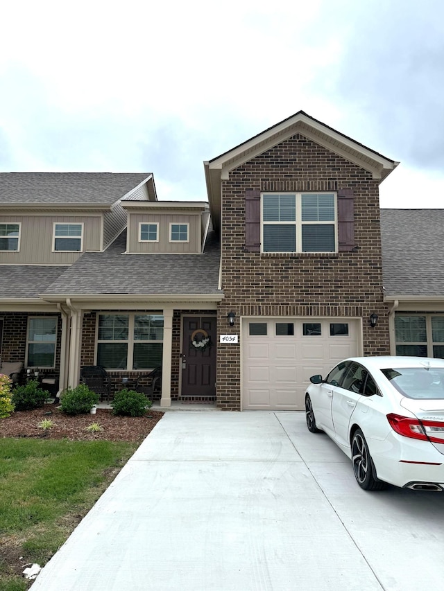 4054 Utica St, Smyrna, TN 37167 - view of front of property featuring concrete driveway, brick siding, a garage, and covered porch