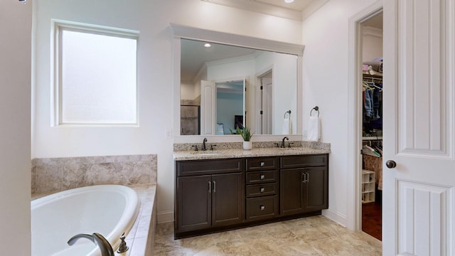 2816 Chatham Place Ct, Thompsons Station, TN 37179 - bathroom with double vanity, a garden tub, ornamental molding, and a walk in closet