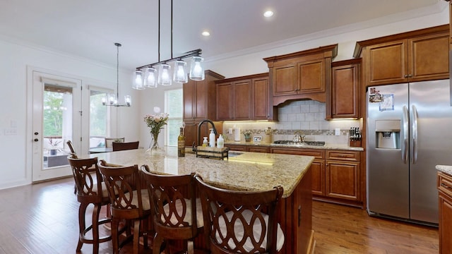 2816 Chatham Place Ct, Thompsons Station, TN 37179 - kitchen featuring appliances with stainless steel finishes, dark wood finished floors, decorative backsplash, crown molding, and a center island with sink