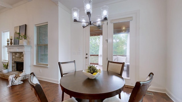 2816 Chatham Place Ct, Thompsons Station, TN 37179 - dining space with wood finished floors, baseboards, a chandelier, and a fireplace with raised hearth