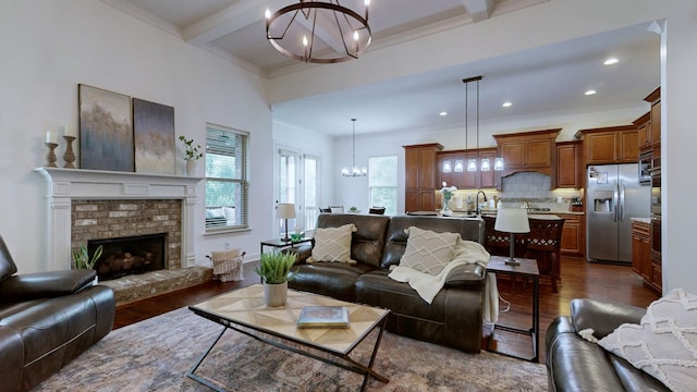 2816 Chatham Place Ct, Thompsons Station, TN 37179 - living room with a chandelier, dark wood finished floors, beam ceiling, ornamental molding, and a fireplace