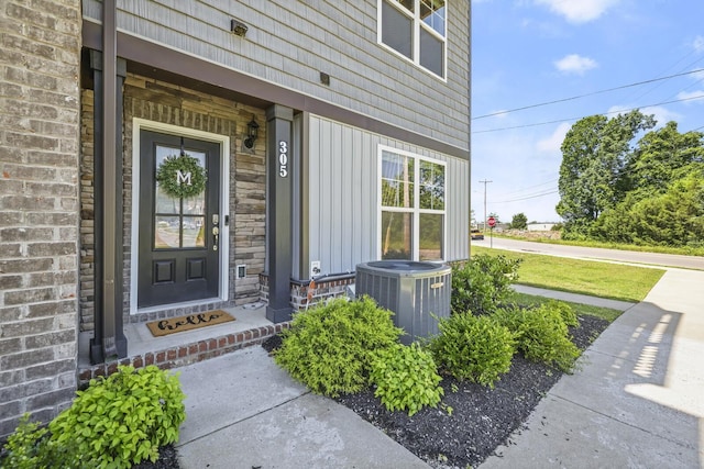 305 Jerry Butler Dr, La Vergne, TN 37086 - view of exterior entry with central AC unit, covered porch, and stone siding
