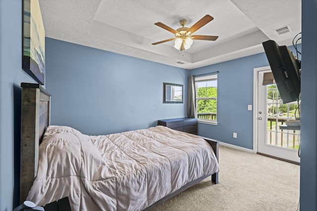 305 Jerry Butler Dr, La Vergne, TN 37086 - carpeted bedroom with a raised ceiling, access to exterior, a textured ceiling, baseboards, and ceiling fan