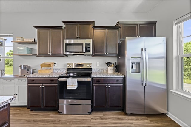 305 Jerry Butler Dr, La Vergne, TN 37086 - kitchen with stainless steel appliances, dark brown cabinetry, dark wood-style floors, light stone countertops, and open shelves