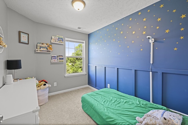 305 Jerry Butler Dr, La Vergne, TN 37086 - bedroom with carpet flooring, a textured ceiling, a wainscoted wall, wallpapered walls, and baseboards