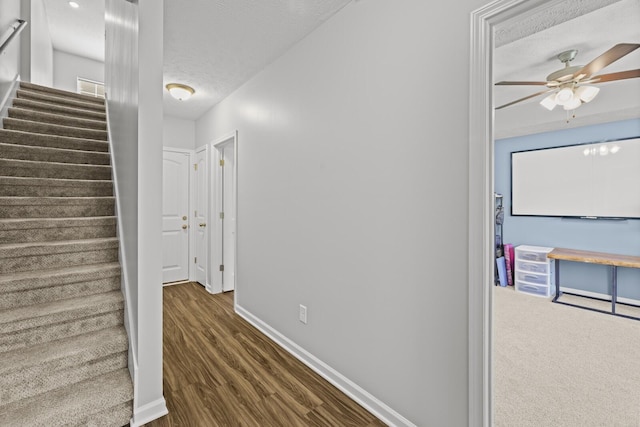 305 Jerry Butler Dr, La Vergne, TN 37086 - hall featuring stairs, a textured ceiling, wood finished floors, and baseboards