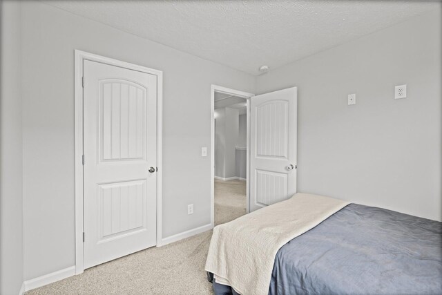 305 Jerry Butler Dr, La Vergne, TN 37086 - carpeted bedroom with baseboards and a textured ceiling
