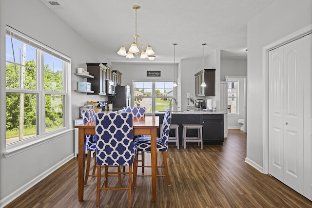 305 Jerry Butler Dr, La Vergne, TN 37086 - dining space featuring baseboards, dark wood-style flooring, and a chandelier