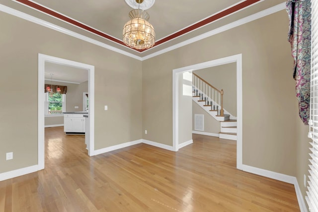 411 Royal Xing, Franklin, TN 37064 - unfurnished room with a chandelier, crown molding, light wood-style flooring, stairway, and baseboards
