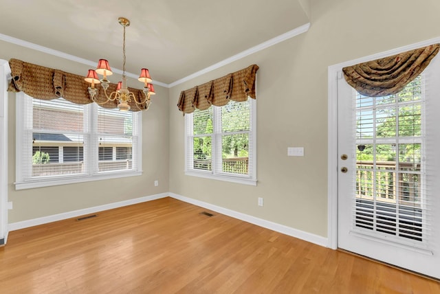 411 Royal Xing, Franklin, TN 37064 - unfurnished dining area with wood finished floors, a chandelier, ornamental molding, and baseboards