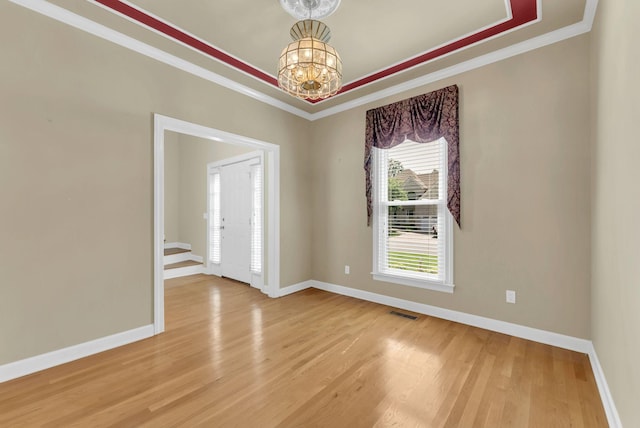 411 Royal Xing, Franklin, TN 37064 - empty room with crown molding, light wood-style flooring, a chandelier, and baseboards