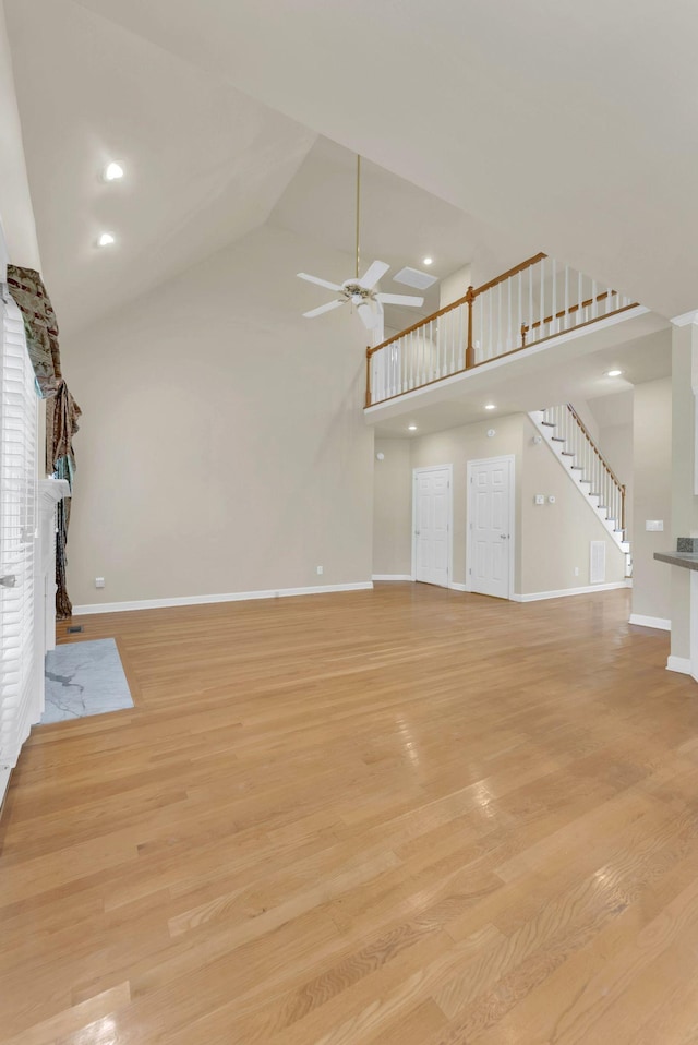 411 Royal Xing, Franklin, TN 37064 - unfurnished living room with a fireplace with flush hearth, high vaulted ceiling, a ceiling fan, baseboards, and light wood-style floors