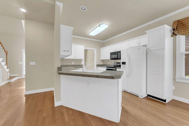 411 Royal Xing, Franklin, TN 37064 - kitchen with white fridge with ice dispenser, black microwave, stainless steel range with electric cooktop, light wood-type flooring, and crown molding