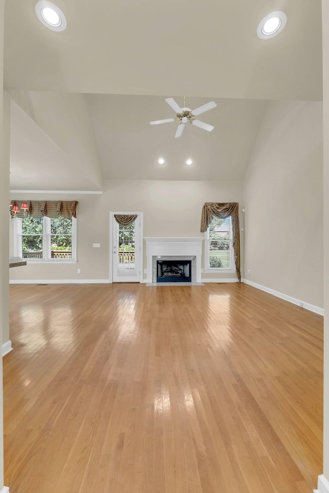 411 Royal Xing, Franklin, TN 37064 - unfurnished living room with a ceiling fan, high vaulted ceiling, light wood finished floors, baseboards, and a fireplace