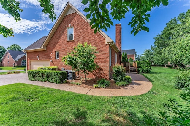 411 Royal Xing, Franklin, TN 37064 - view of home's exterior featuring brick siding, a wooden deck, a chimney, a lawn, and central AC unit
