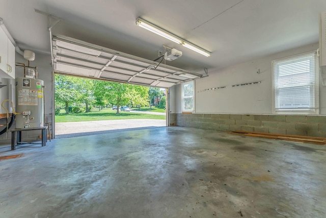 411 Royal Xing, Franklin, TN 37064 - garage with water heater, a garage door opener, and concrete block wall