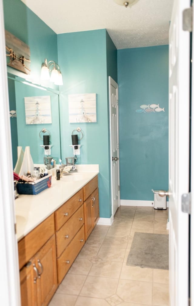 1005 Goldfinch Trl, Portland, TN 37148 - full bathroom featuring double vanity, tile patterned flooring, and baseboards