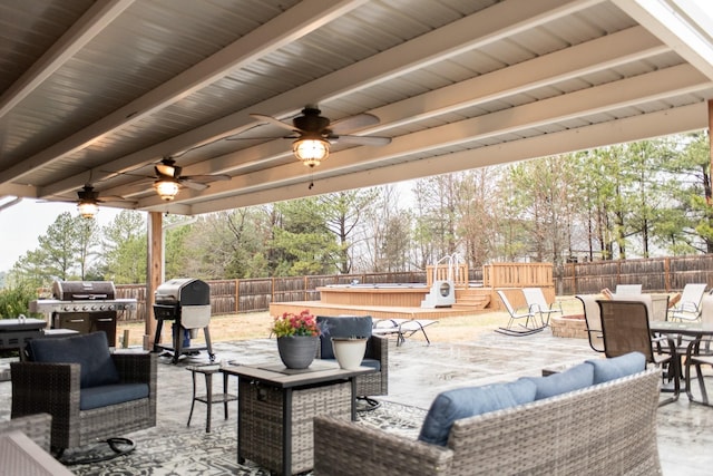 1005 Goldfinch Trl, Portland, TN 37148 - fenced backyard with an outdoor hangout area, outdoor dining space, a ceiling fan, a grill, and a patio