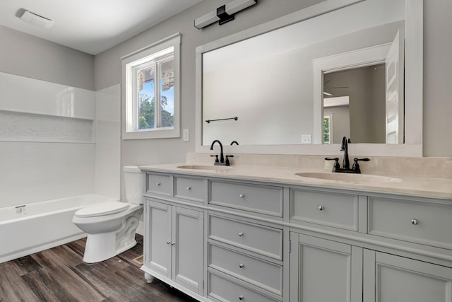 120 E Boiling Springs Rd E, Portland, TN 37148 - bathroom with double vanity, wood finished floors, toilet, and shower / tub combination