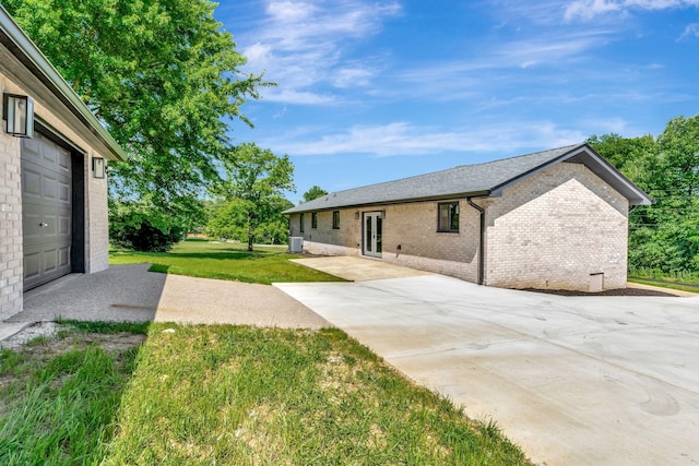 120 E Boiling Springs Rd E, Portland, TN 37148 - view of green lawn featuring concrete driveway, french doors, and cooling unit
