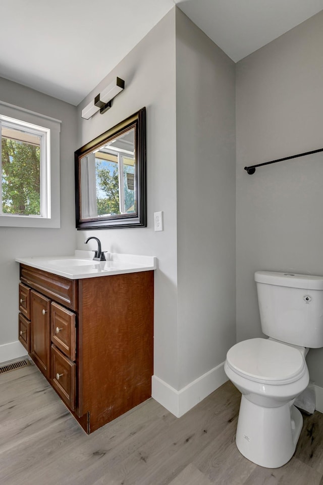 120 E Boiling Springs Rd E, Portland, TN 37148 - bathroom with wood finished floors, vanity, baseboards, and toilet