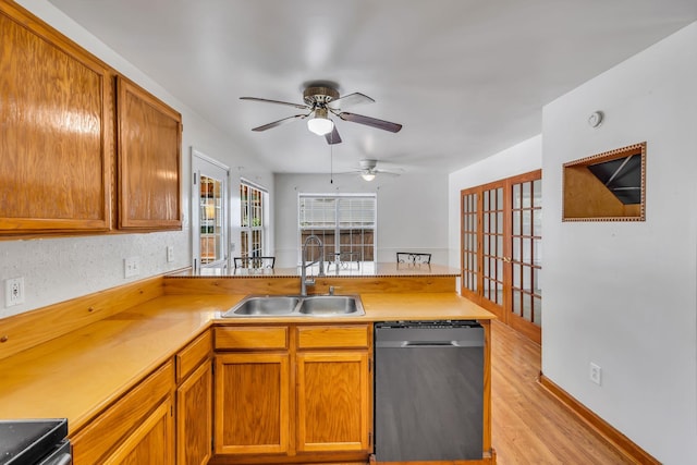 1510 Walnut Hills Dr, Chapel Hill, TN 37034 - kitchen with stainless steel dishwasher, a ceiling fan, light countertops, light wood-style flooring, and brown cabinetry