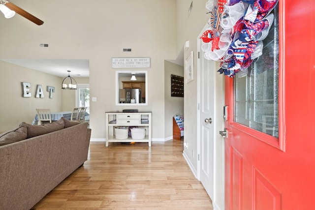 2684 Hidden Ridge Ct, Clarksville, TN 37043 - entryway with light wood-style floors, a ceiling fan, a chandelier, baseboards, and a high ceiling