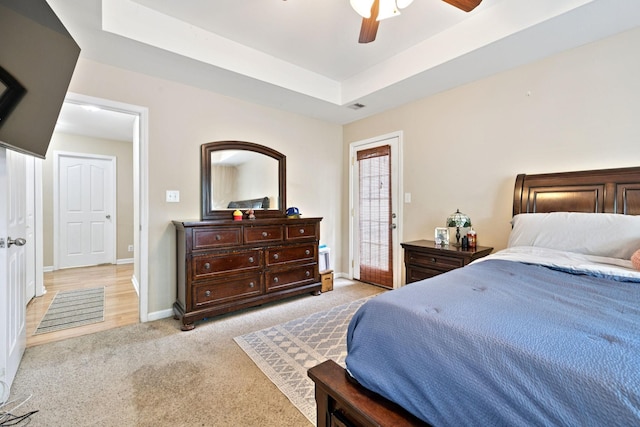 2684 Hidden Ridge Ct, Clarksville, TN 37043 - bedroom featuring light carpet, baseboards, ceiling fan, and a raised ceiling