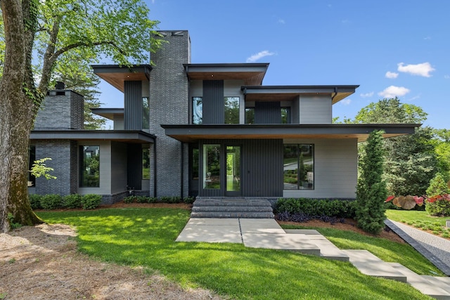 1601 Windy Ridge Dr, Brentwood, TN 37027 - contemporary home featuring a chimney, a front yard, and a porch