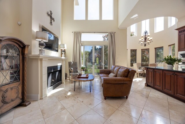 891 Fairington Pvt Way, Gallatin, TN 37066 - living room with a high ceiling, a chandelier, and a glass covered fireplace