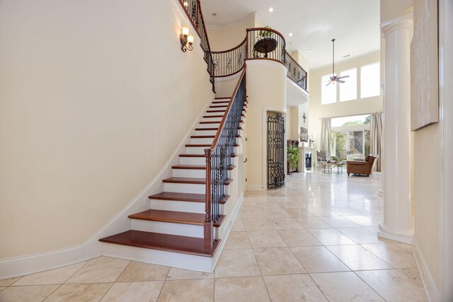 891 Fairington Pvt Way, Gallatin, TN 37066 - staircase featuring a ceiling fan, ornate columns, baseboards, and a high ceiling