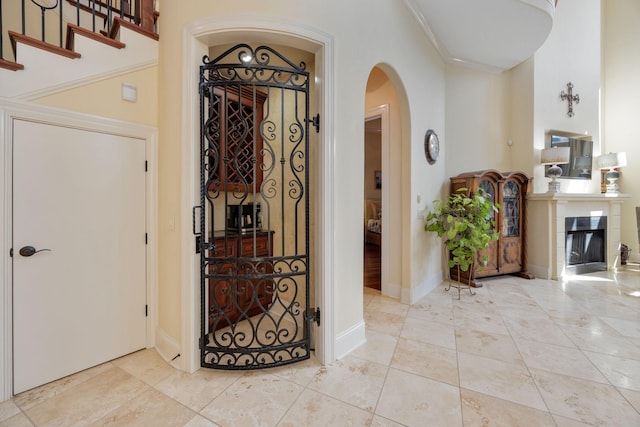 891 Fairington Pvt Way, Gallatin, TN 37066 - entrance foyer featuring arched walkways, a tiled fireplace, and baseboards
