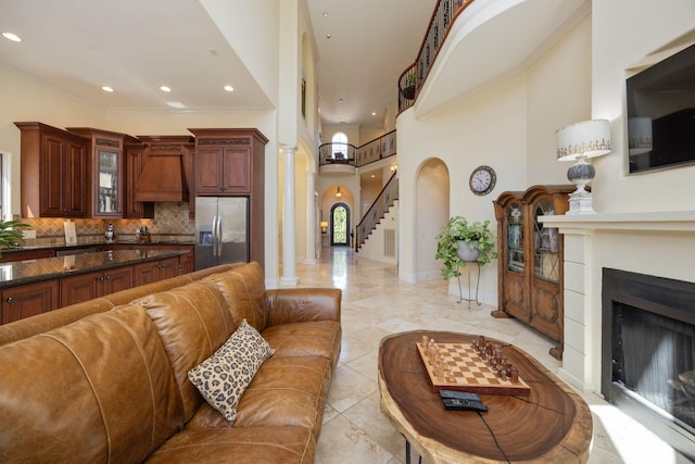 891 Fairington Pvt Way, Gallatin, TN 37066 - living area featuring a fireplace, stairs, arched walkways, baseboards, and recessed lighting