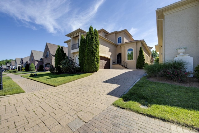 891 Fairington Pvt Way, Gallatin, TN 37066 - mediterranean / spanish home with decorative driveway, an attached garage, a front lawn, and stucco siding