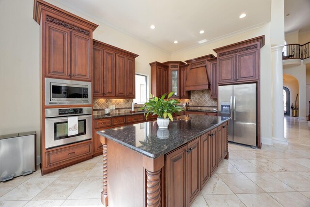891 Fairington Pvt Way, Gallatin, TN 37066 - kitchen featuring stainless steel appliances, arched walkways, tasteful backsplash, dark stone countertops, and crown molding